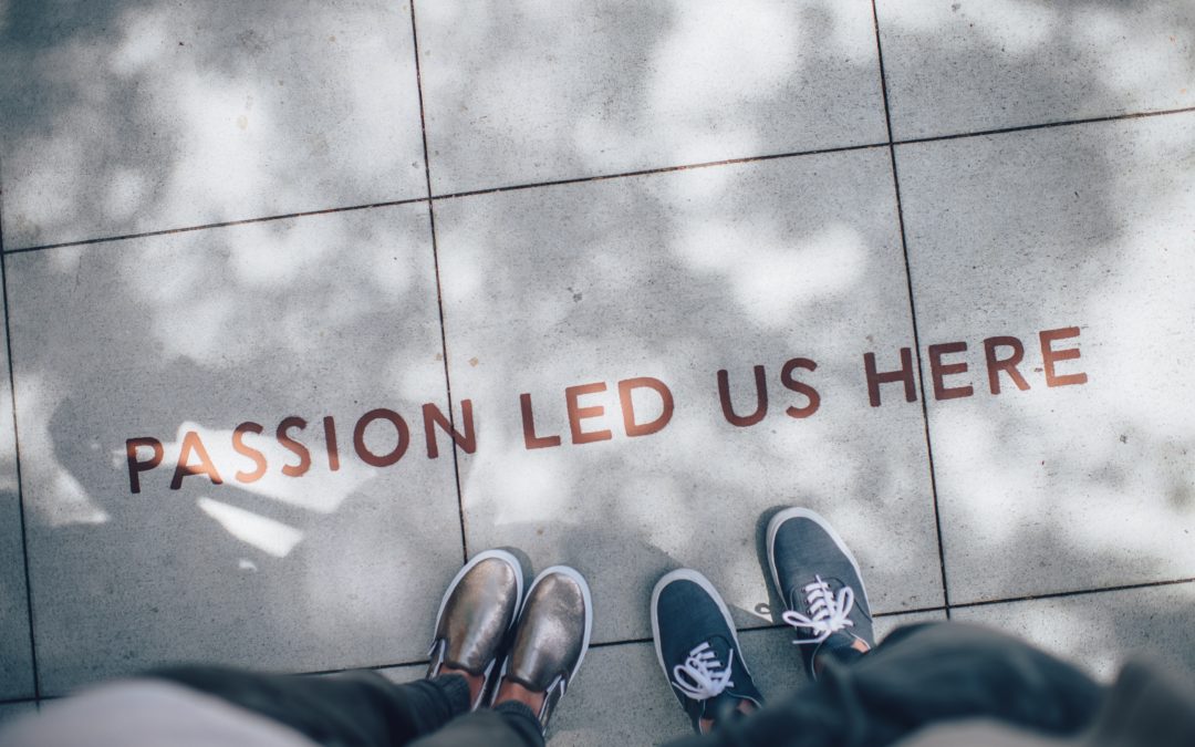 "Passion Led Us Here" painted on a sidewalk