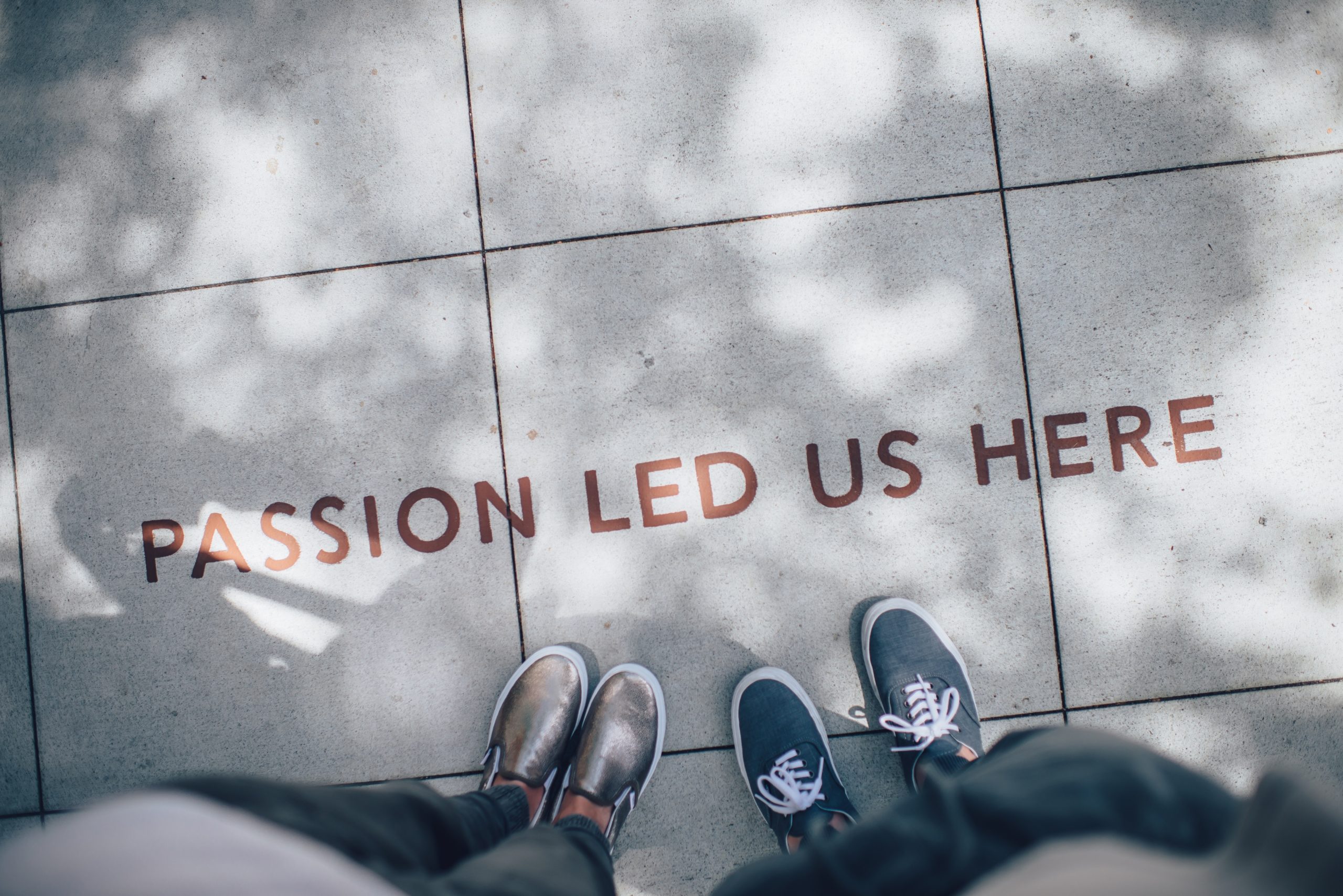 "Passion Led Us Here" painted on a sidewalk