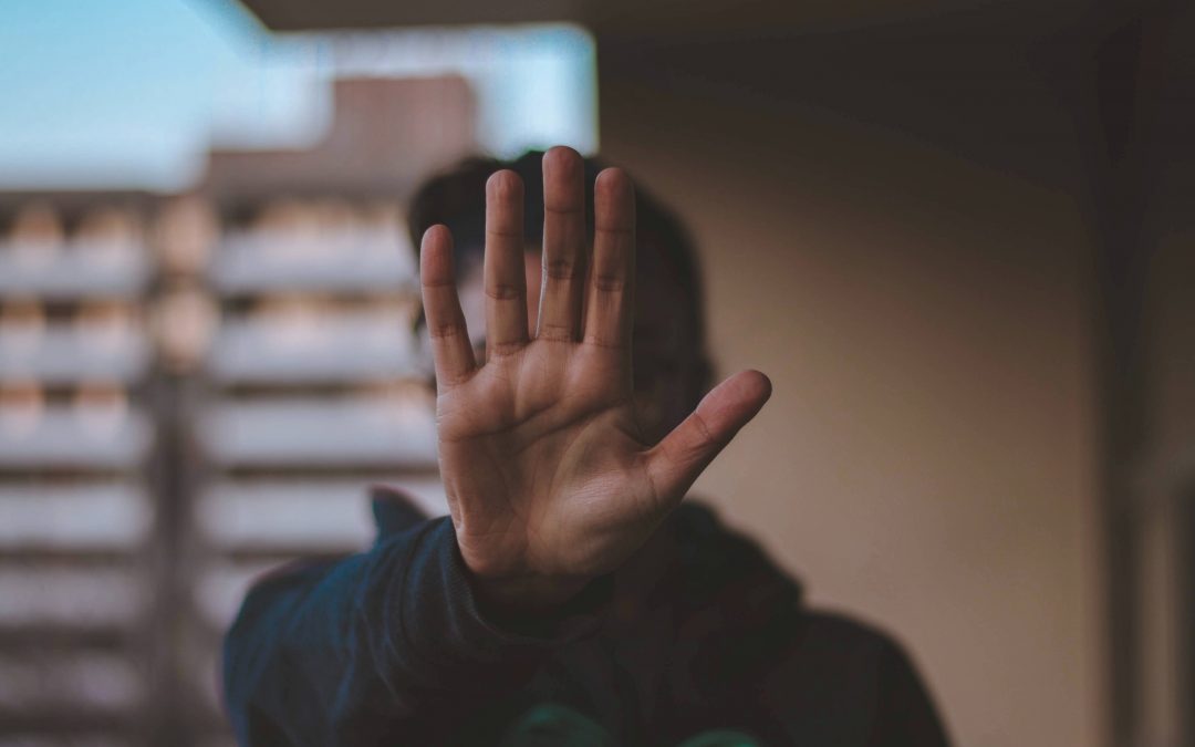 Person holding out there hand to signal Stop