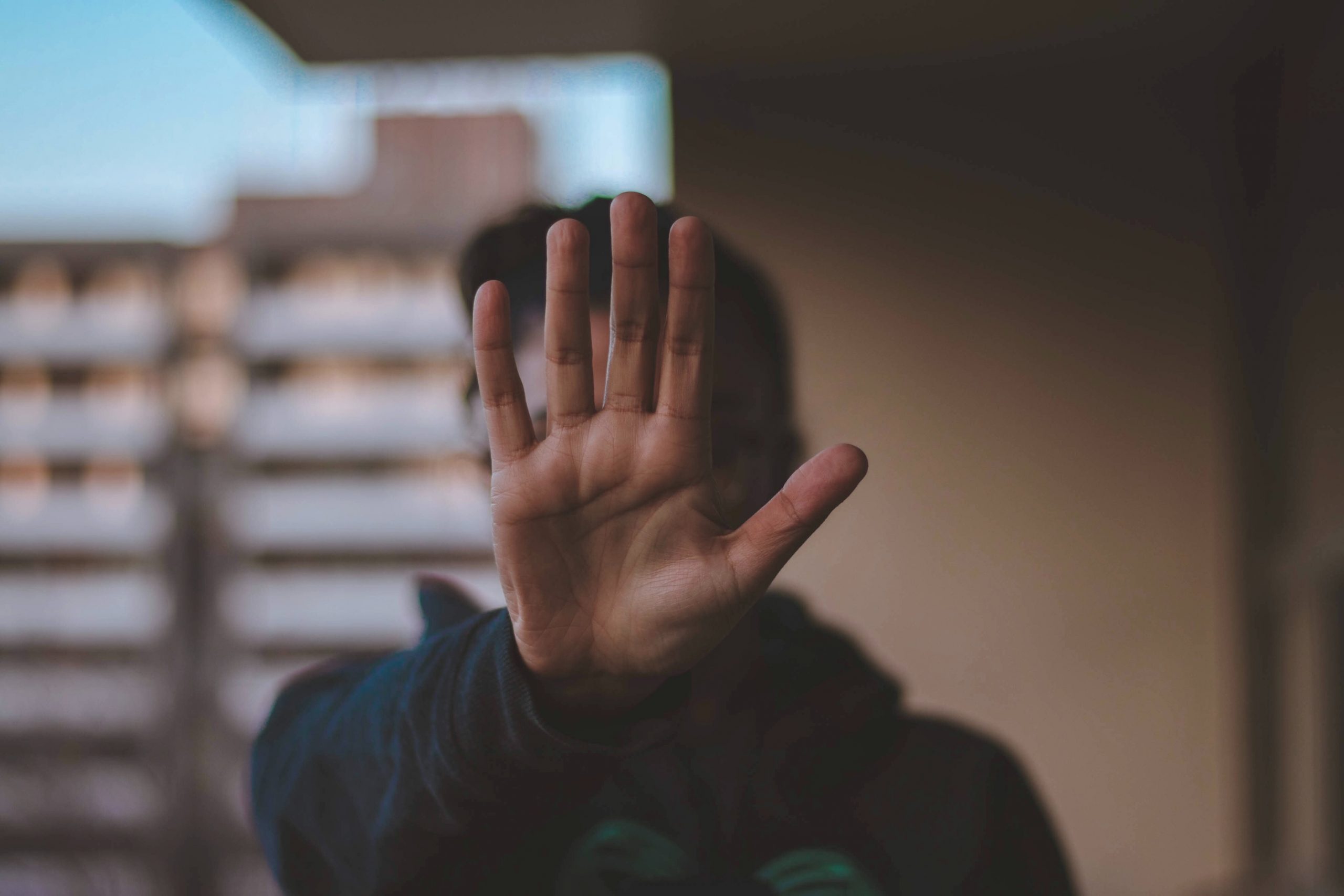 Person holding out there hand to signal Stop