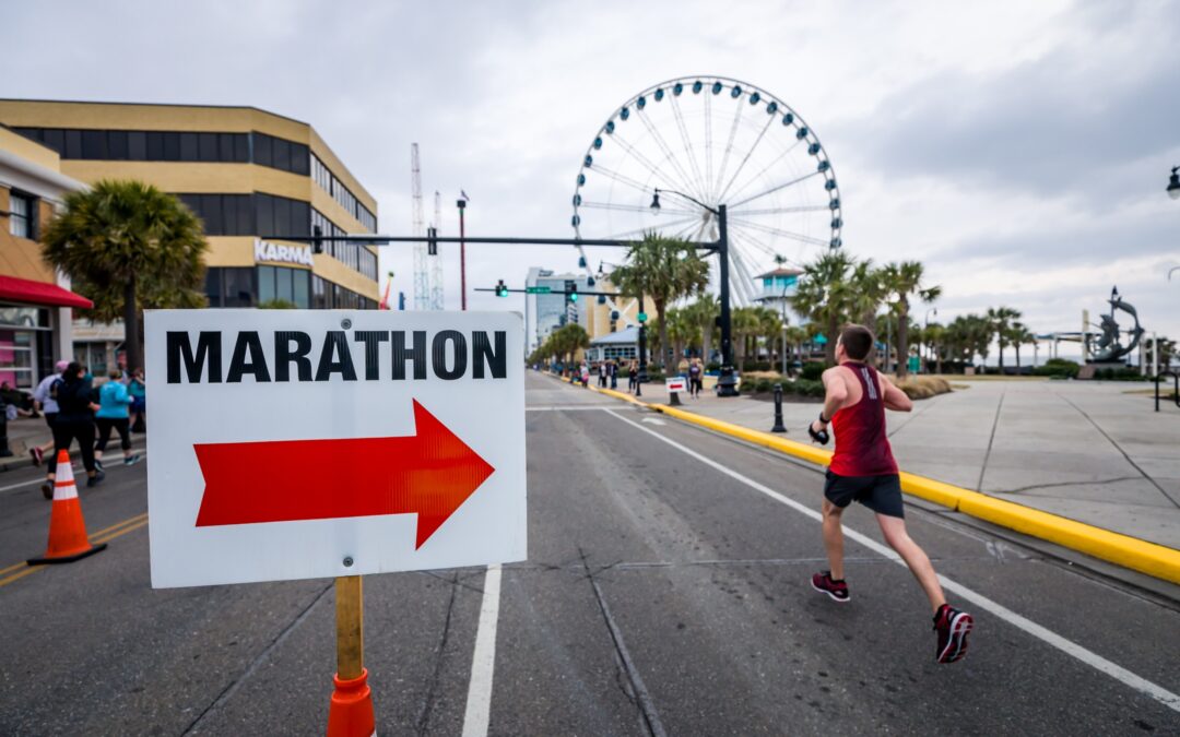 Marathon sign pointing at a runner