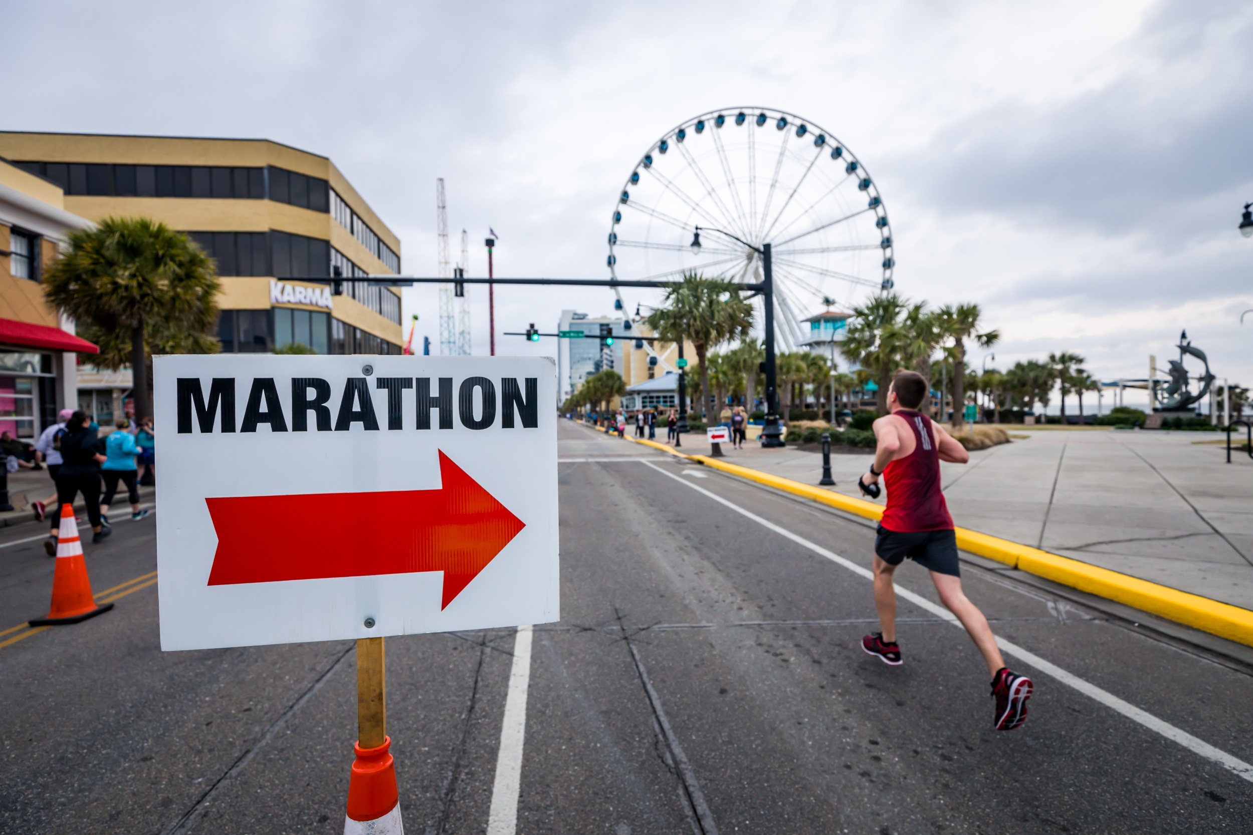 Marathon sign pointing at a runner