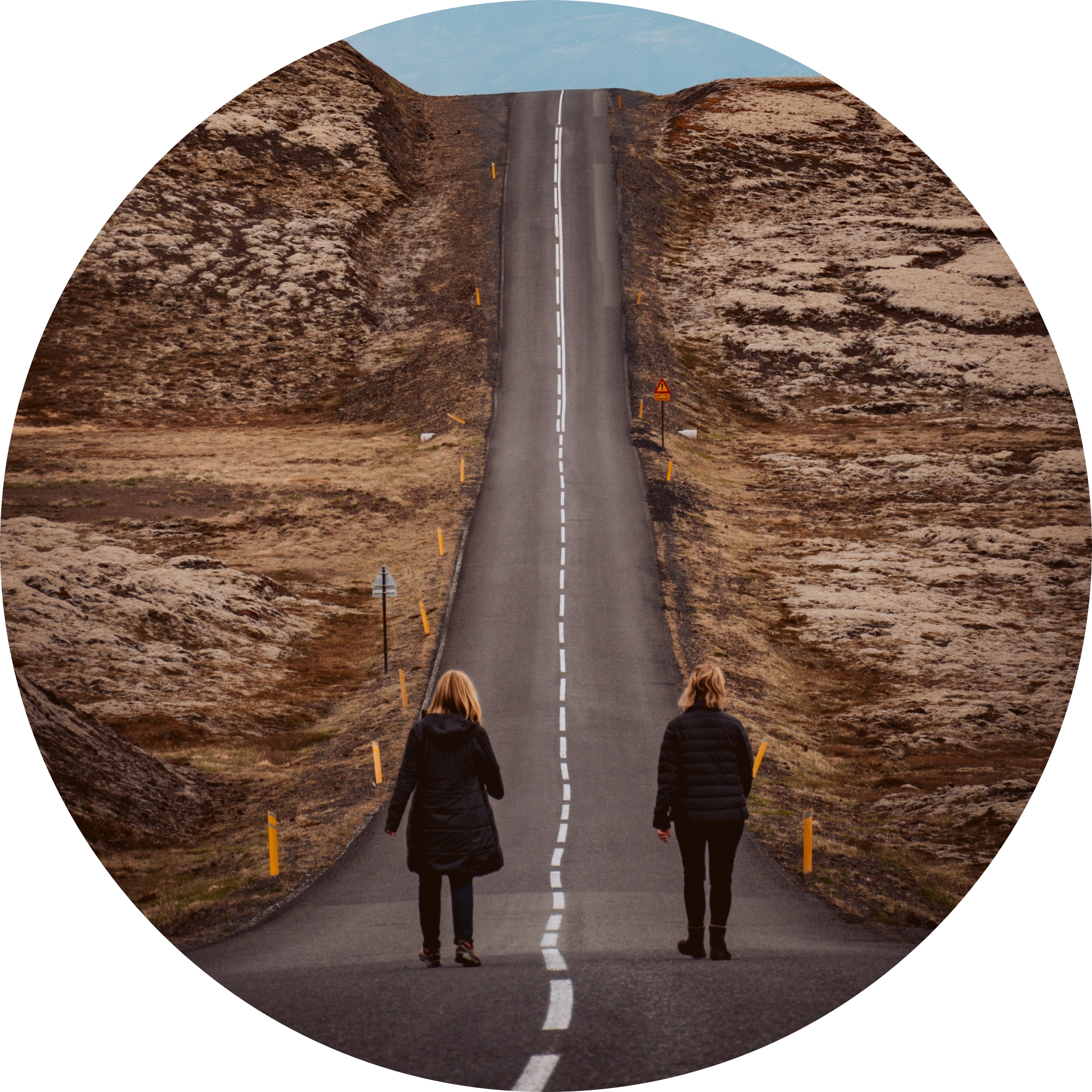 Two people walking a road together