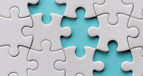 White puzzle with three missing pieces on a blue background