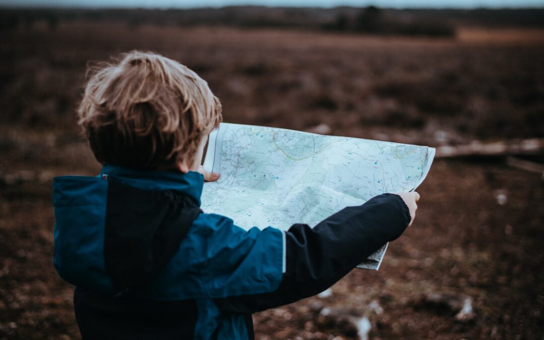 Little boy looking at a map
