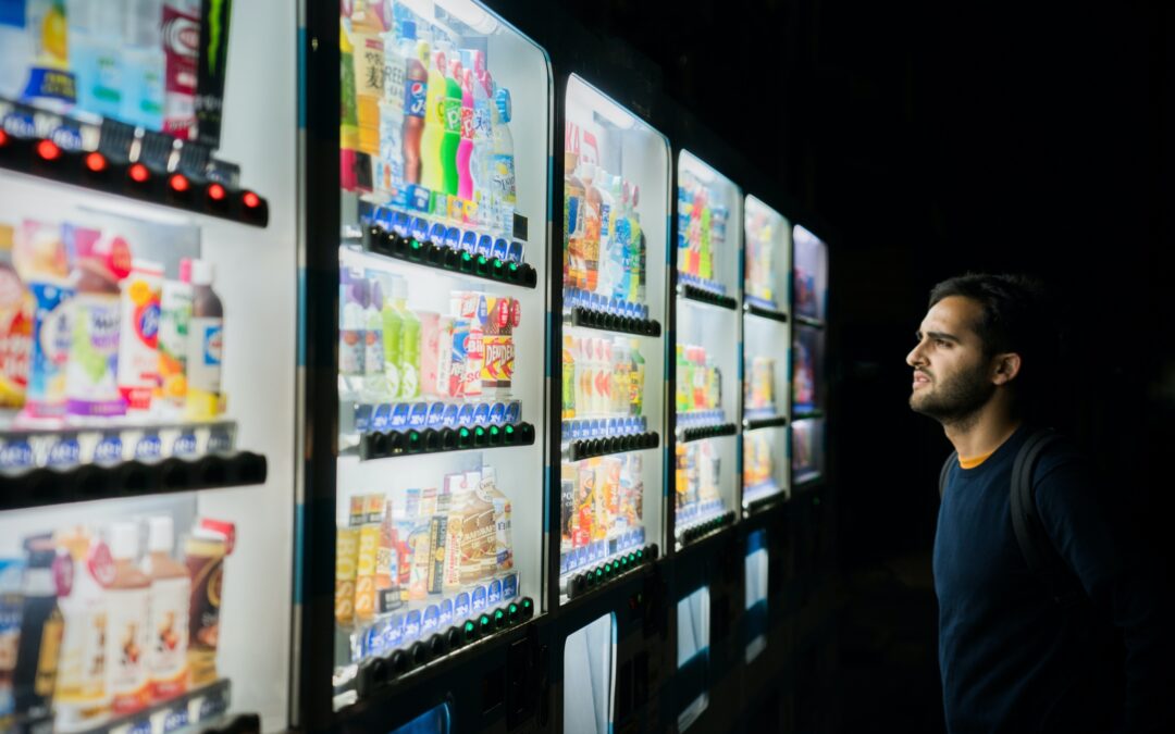 Man looking at a vending machine full of food