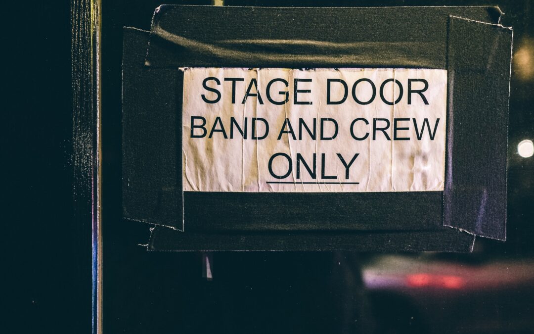 Sign taped to a door that reads "Stage Door. Band and Crew Only"