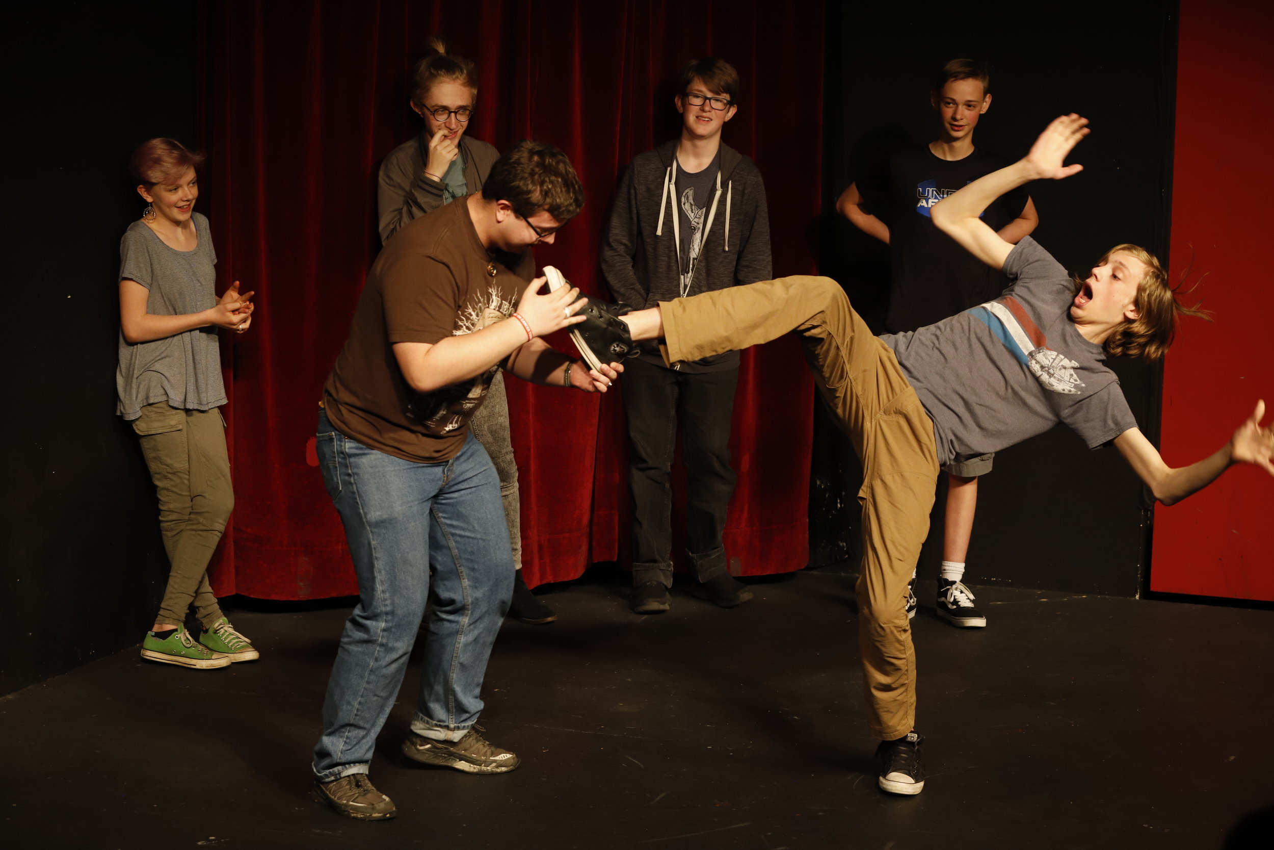 Improv scene of one man trying to eat another man's shoe