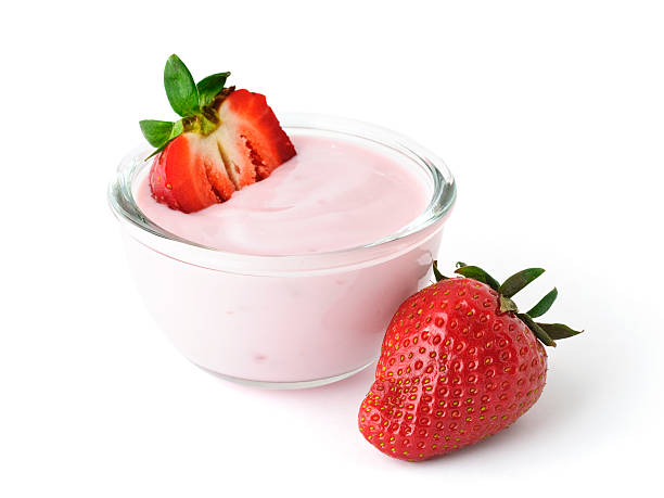 Fresh juicy strawberry with yogurt in a glass bowl isolated on white background