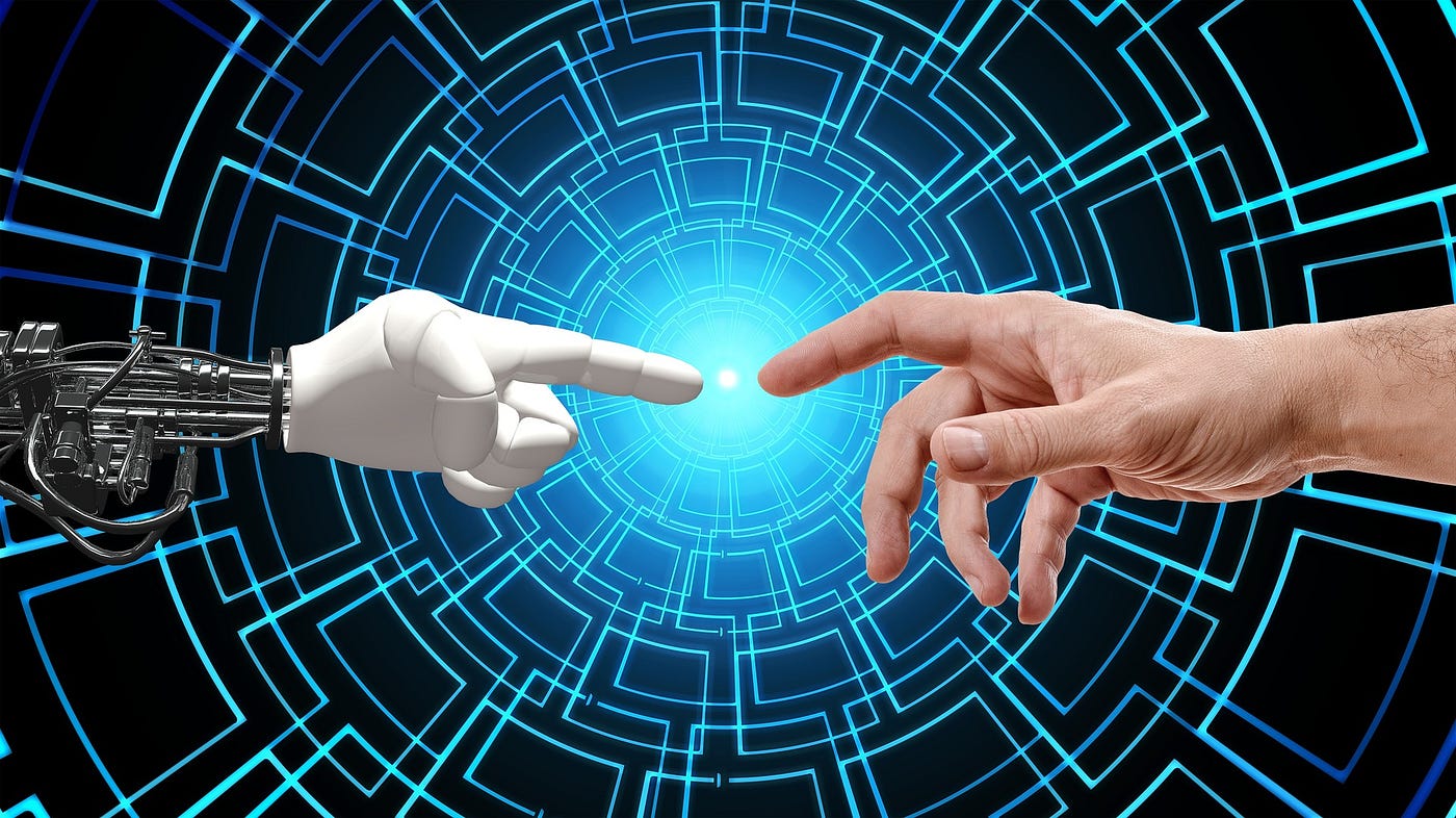 A robot hand and a human hand reaching towards each other