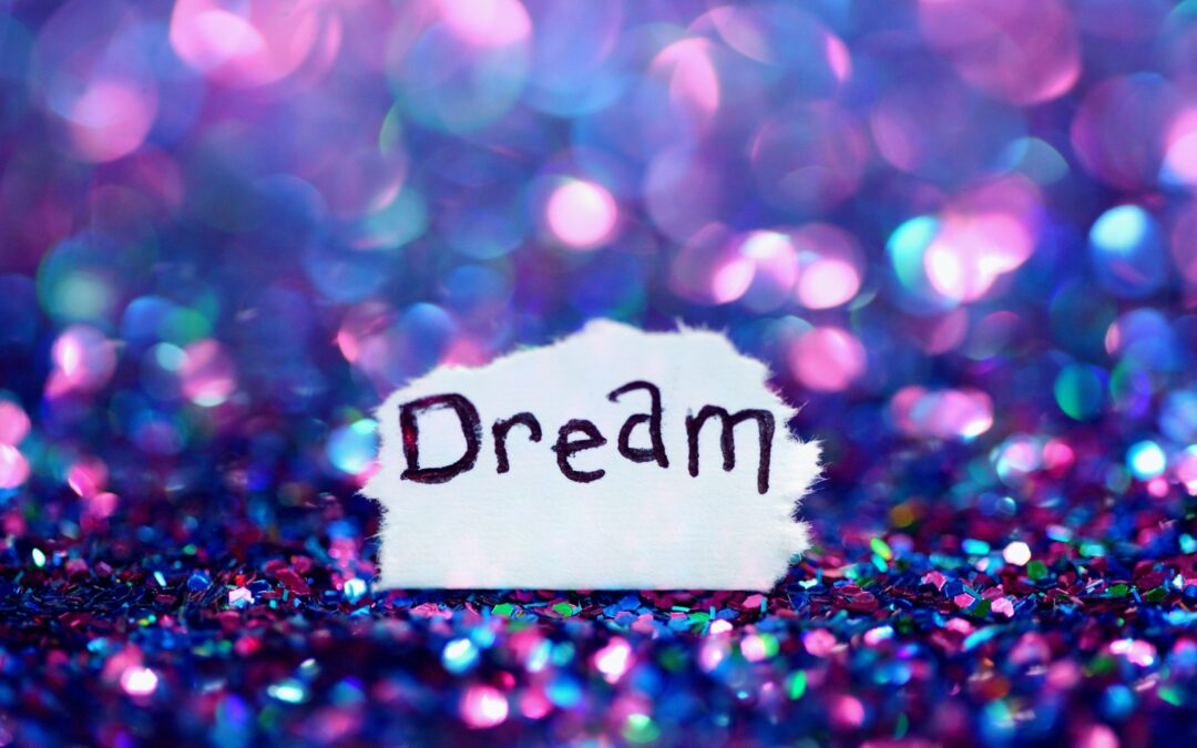 A simple message to dream with shimmery purple and pink glitter bokeh.