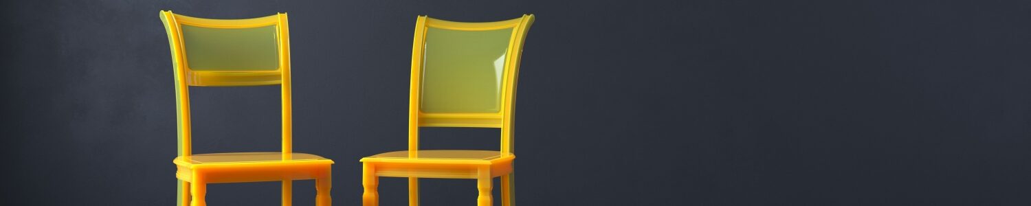 Two yellow chairs against a gray background