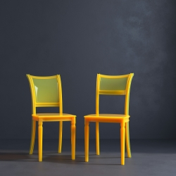 Two yellow chairs against a gray backdrop